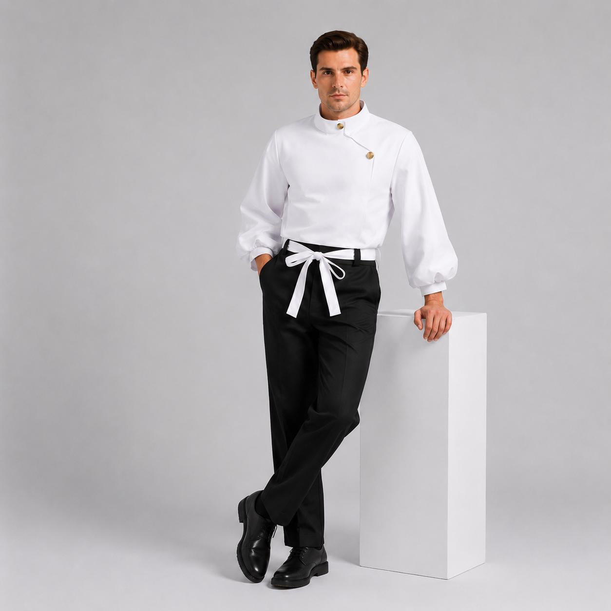 May include: A white long-sleeved shirt with a high collar, gold-toned buttons, and a diagonal front closure, paired with black trousers featuring a white fabric belt tied at the waist. The shirt has full sleeves and the trousers have a straight-leg cut.