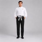 May include: A white long-sleeved shirt with a high collar, an asymmetrical button closure, and full sleeves paired with black trousers featuring a white tie-waist belt. The ensemble is completed with black dress shoes on a neutral background.
