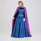 May include: A floor-length blue gown with a black bodice, long black sleeves, and a purple cape. The skirt features a floral pattern in shades of blue, pink, and white. The bodice has a gold trim, and the cape is secured with a silver brooch.