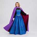 May include: A floor-length blue gown with a black long-sleeved bodice, a high collar, and a full skirt featuring a repeating floral pattern. A long purple cape with a magenta lining and a decorative silver brooch is draped over the shoulders.