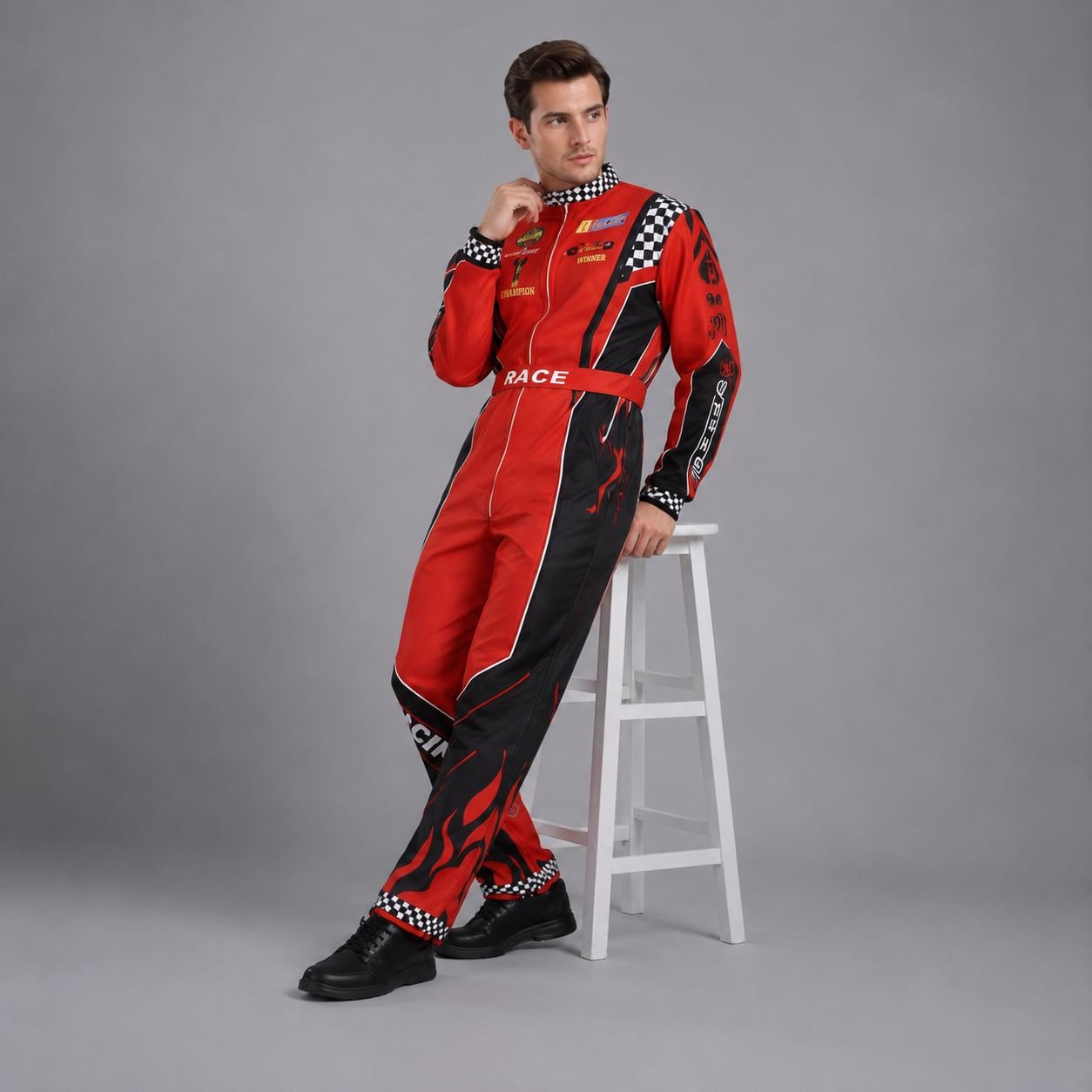 May include: A red and black racing jumpsuit featuring a checkered pattern on the collar and cuffs, a front zipper, and the word RACE printed on the waist belt. The garment includes various sponsor-style patches and flame graphics on the legs.