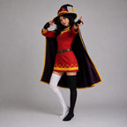 May include: A costume featuring a red tunic with a yellow zigzag hem, a dark purple cape with yellow trim, and a matching pointed hat with a yellow emblem. The outfit includes black fingerless gloves, one white thigh-high sock, and one black sock.