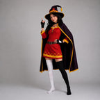 May include: A costume featuring a red tunic with yellow trim, a dark purple cape with yellow edges, and a matching pointed hat with a red and yellow emblem. The outfit includes black fingerless gloves and mismatched thigh-high socks, one white and one black.