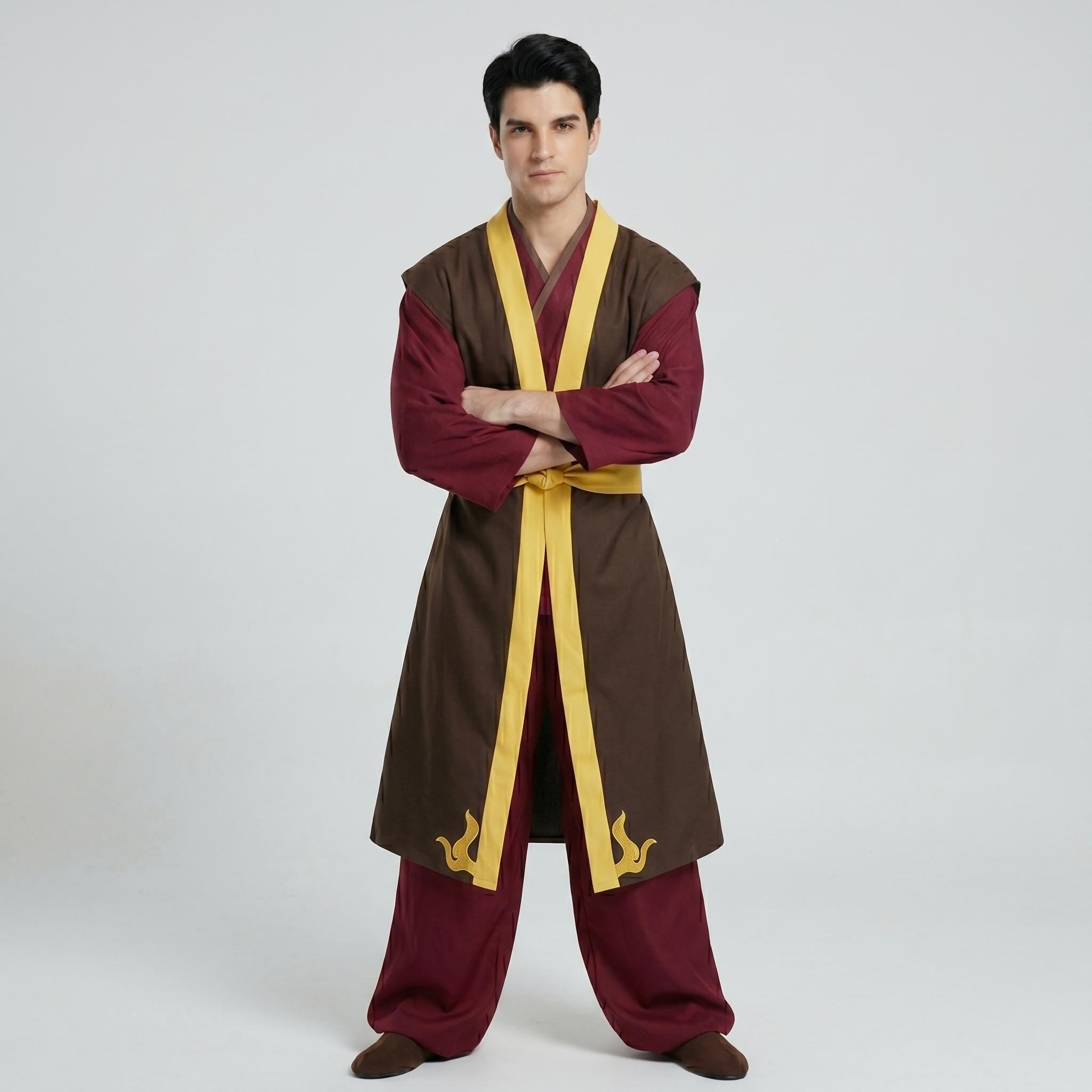 May include: A long-sleeved maroon tunic worn under a sleeveless brown overcoat with yellow trim. The overcoat features a yellow waist tie and yellow flame-like embroidery at the hem. The outfit includes matching maroon trousers and brown shoes.