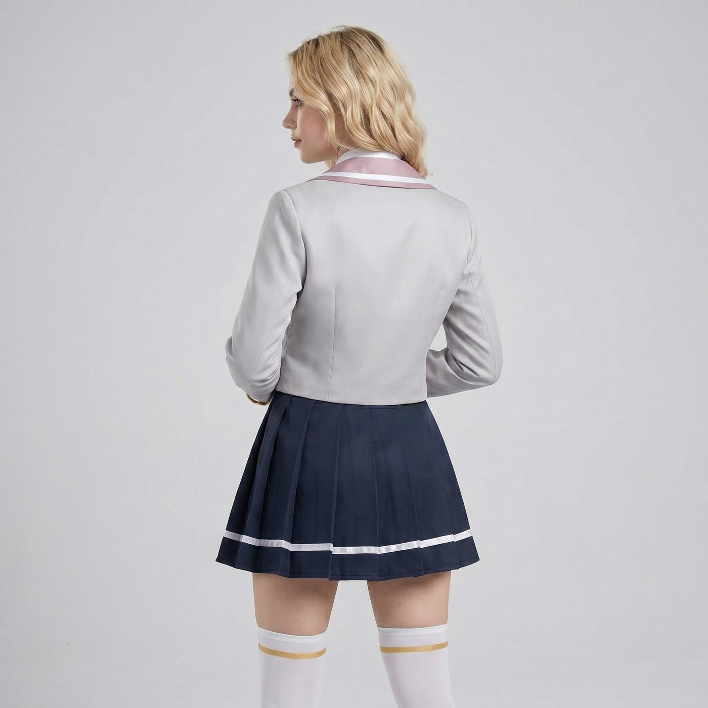 May include: A light gray long-sleeved blazer with a pink collar and a dark navy blue pleated skirt featuring a thin white horizontal stripe near the hem, paired with white knee-high socks that have a thin gold band at the top edge.