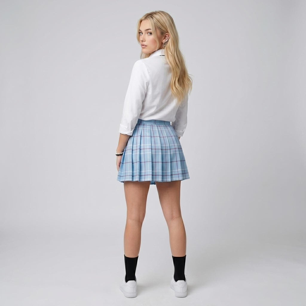 May include: A white long-sleeved button-down shirt paired with a light blue pleated mini skirt featuring a white and dark blue plaid pattern. The skirt has a high waist and a structured, flared silhouette that falls above the knee.