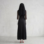 May include: A person wearing a black dress, veil, and white gloves, standing with their back to the camera. The dress is floor-length, and the veil covers the head and shoulders. The person is wearing white high heels.