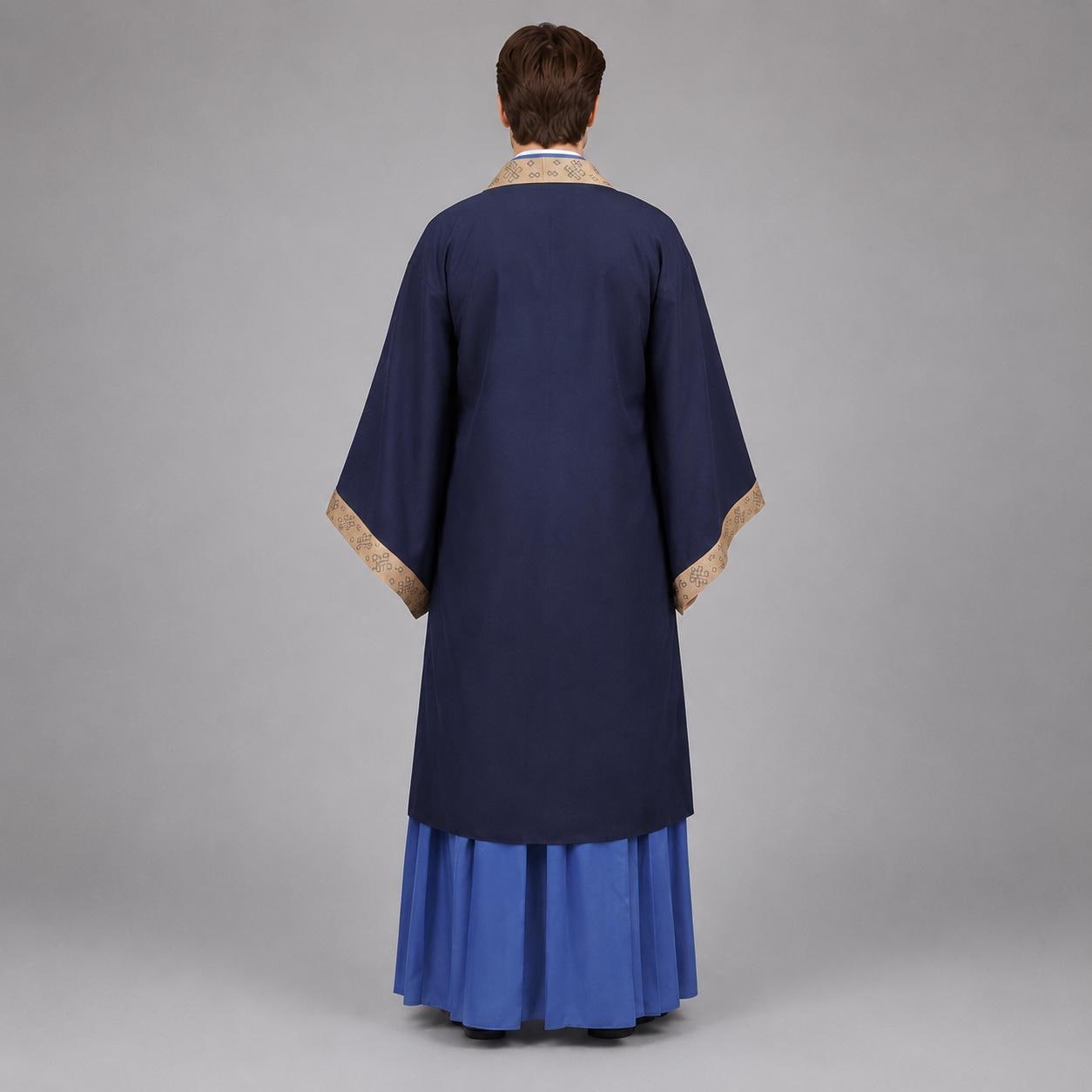 May include: A dark blue robe featuring wide sleeves with tan patterned trim along the collar and cuffs. The garment is worn over a bright blue pleated skirt that reaches the floor. The view shows the back of the attire with a solid color design.