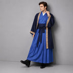 May include: A blue wrap-style robe with a white inner collar, layered under a dark navy open-front coat featuring tan patterned trim along the edges. The outfit includes a wide dark navy sash tied at the waist and a long, pleated blue skirt.