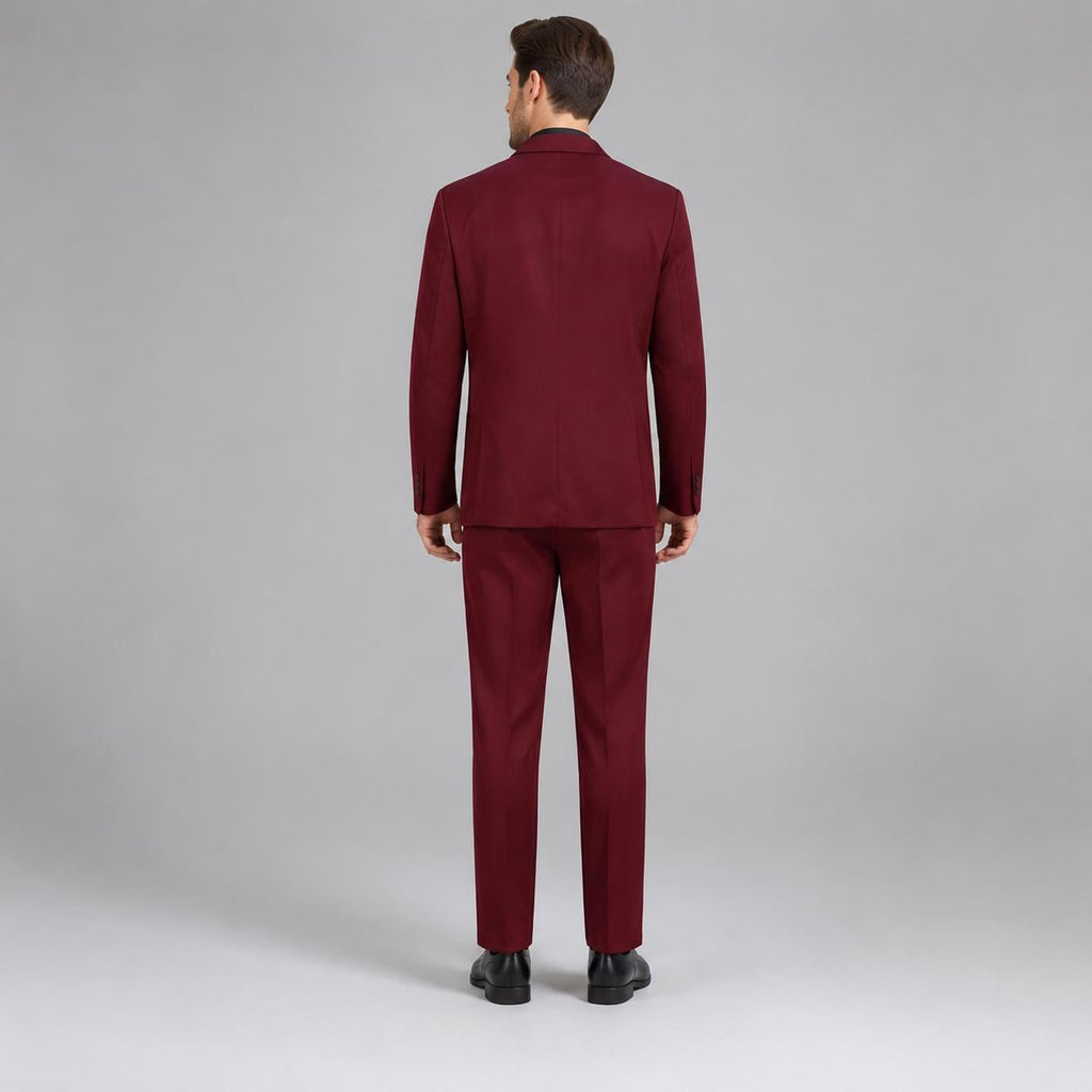 May include: A solid burgundy suit consisting of a single-breasted blazer with a notched lapel and matching trousers. The suit is shown from the back, featuring a clean, tailored fit with a center vent on the jacket and straight-leg pants.