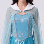 May include: A light blue dress featuring a white faux fur collar and long sheer sleeves. The bodice has a central panel with silver star and scroll patterns, bordered by silver sequin trim, and side panels with a subtle textured dot design.