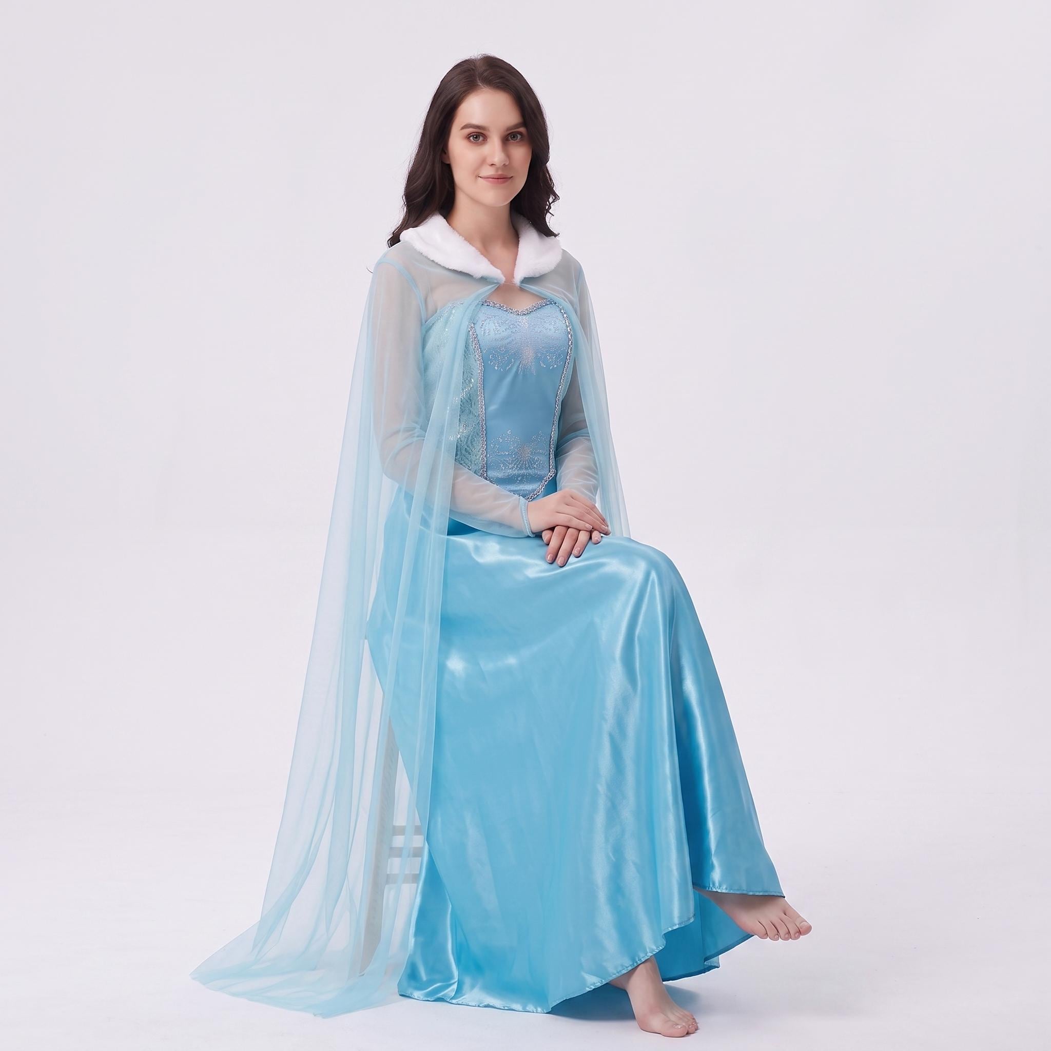 May include: A floor-length light blue satin dress featuring a sweetheart neckline, sheer long sleeves, and a matching sheer cape with a white faux fur collar. The bodice is embellished with silver embroidery and sequins in a snowflake pattern.