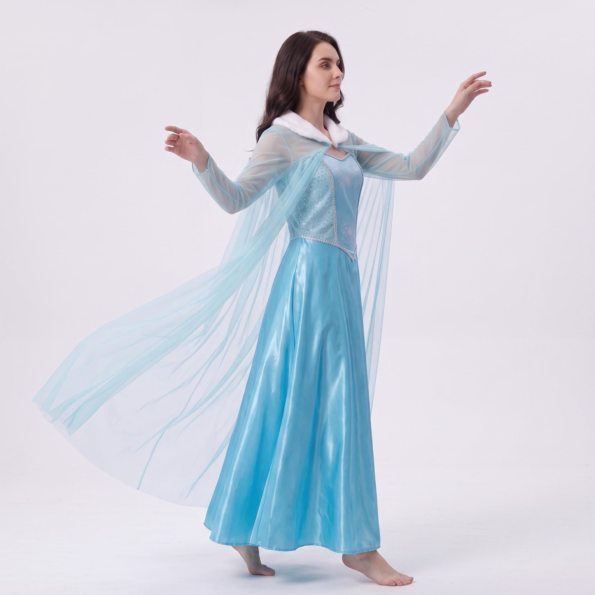 May include: A floor-length light blue dress featuring a fitted bodice with a shimmering texture, long sheer sleeves, and a white faux fur collar. A long, translucent light blue cape is attached to the back, flowing outward from the shoulders.