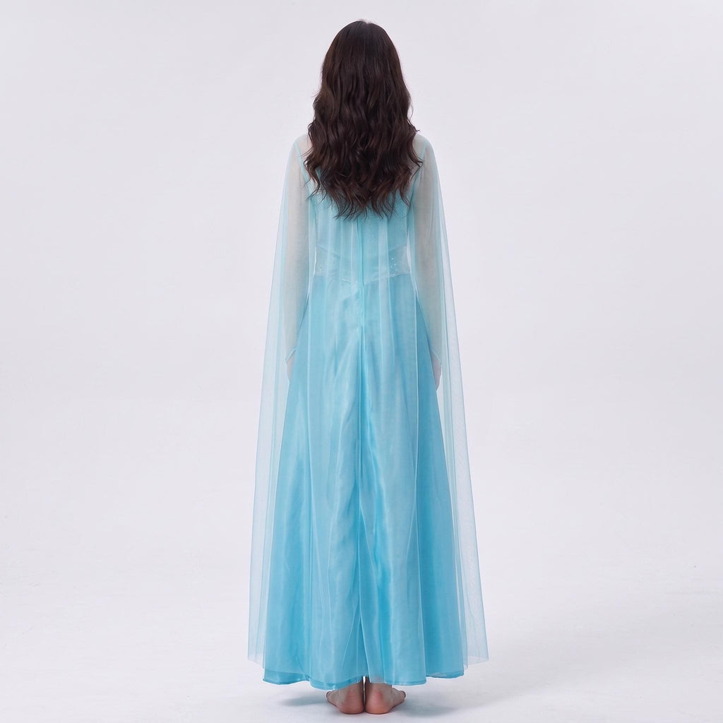 May include: A floor-length light blue dress featuring a sheer cape overlay that extends from the shoulders to the hem. The garment has long sheer sleeves and a solid blue skirt portion, providing a layered appearance with a flowing silhouette.
