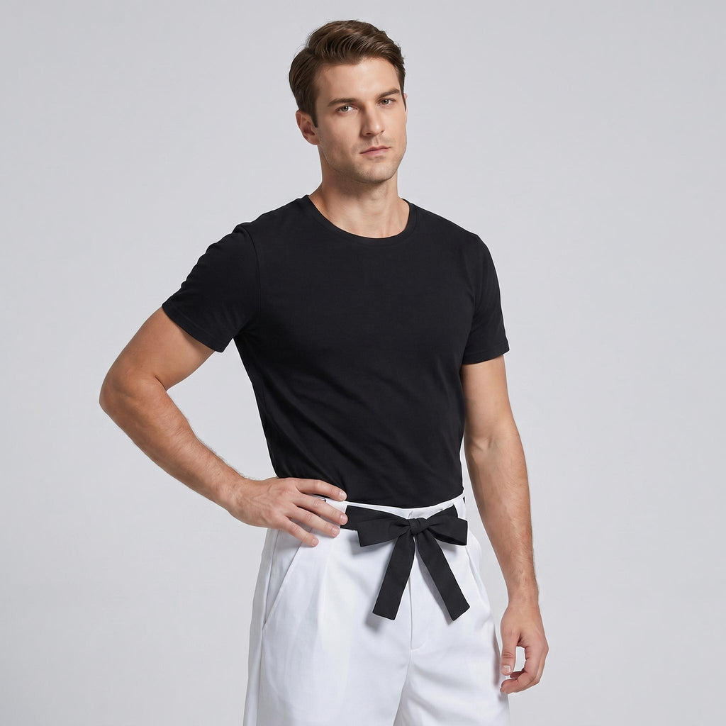 May include: A black short-sleeved crew neck t-shirt paired with white trousers featuring a black fabric belt tied in a bow at the waist. The t-shirt has a plain design, and the trousers have a structured fit with a visible front waistband tie.