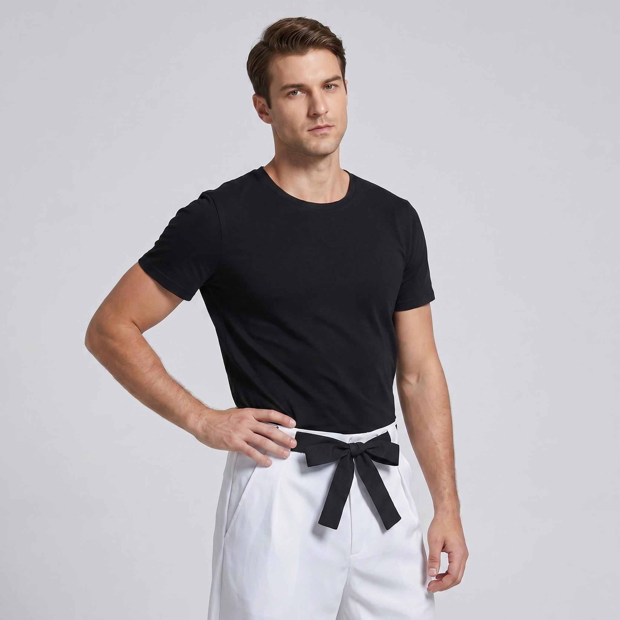 May include: A black short-sleeved crew neck t-shirt paired with white trousers featuring a black fabric belt tied in a bow at the waist. The t-shirt has a plain design, and the trousers have a structured fit with a visible front waistband tie.