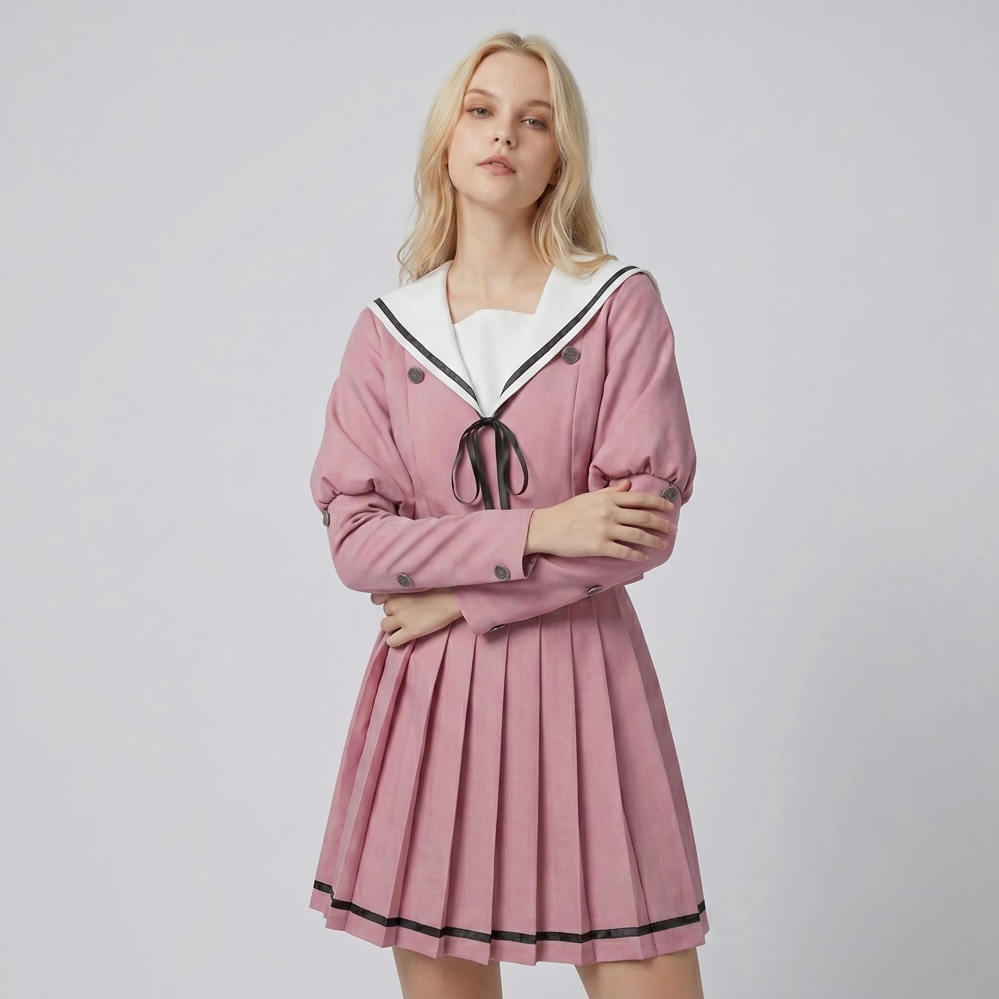 May include: A dusty pink long-sleeved dress featuring a white sailor-style collar with black trim, a black ribbon tie at the neckline, and a pleated skirt. The bodice includes double-breasted buttons and the sleeves have buttoned cuffs.